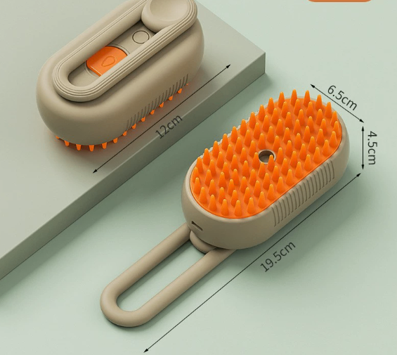 A gray and white cat lies on a beige carpet while a person uses a gray pet grooming brush with orange bristles. Another view of the same pet brush sits nearby on the carpet in a bright, modern living room.
