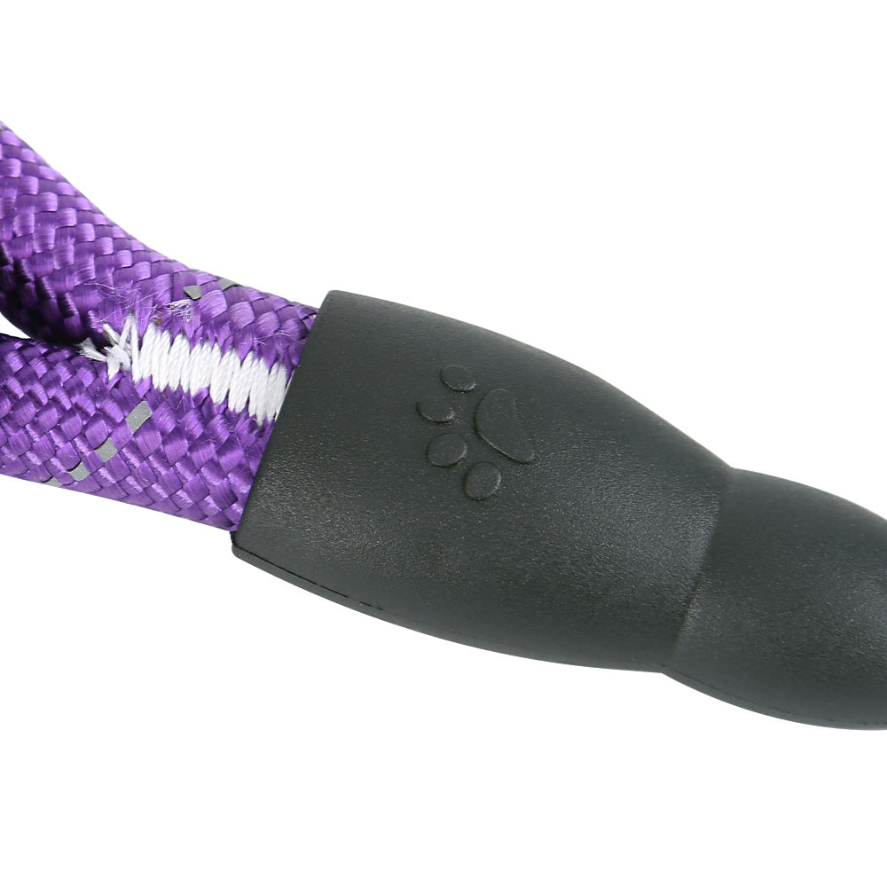 Close-up of a purple and white braided dog leash with a black handle on a white background